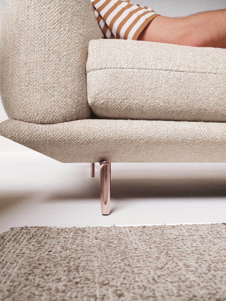Elegant sectional with heightened backrests for superior comfort, minimal base, and decorative stitching, combining sophistication with supported relaxation. | Dragées by Calia Italia