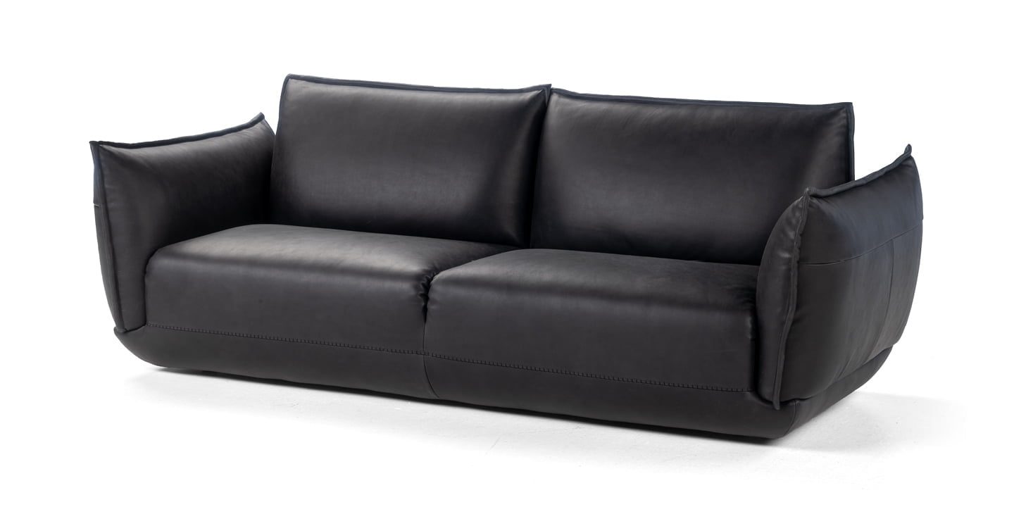 The Éclair sofa features an innovative design with sculptural volumes, decorative stitching, and comfortable seating, available in various sizes for modern and attractive interiors. | L'Eclair by Calia Italia