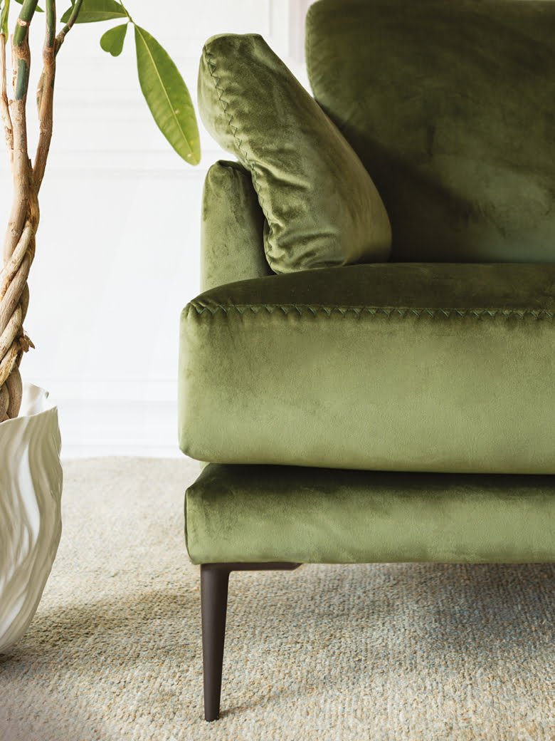 Elegant Fleur chair with stylish pin-shaped legs and sophisticated stitches, ideal for both snug homes and professional spaces, offering comfort in compact form with option for leather or removable fabric. | Fleur by Calia Italia