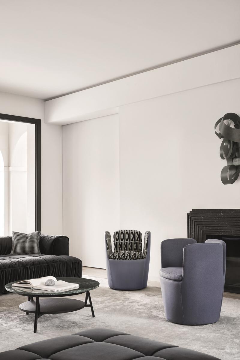 Low round marble coffee table with integrated magazine rack | Cradle by Arflex