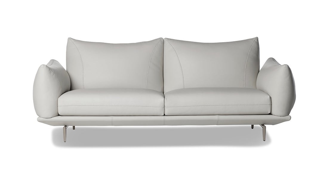 Elegant sectional with heightened backrests for superior comfort, minimal base, and decorative stitching, combining sophistication with supported relaxation. | Dragées by Calia Italia