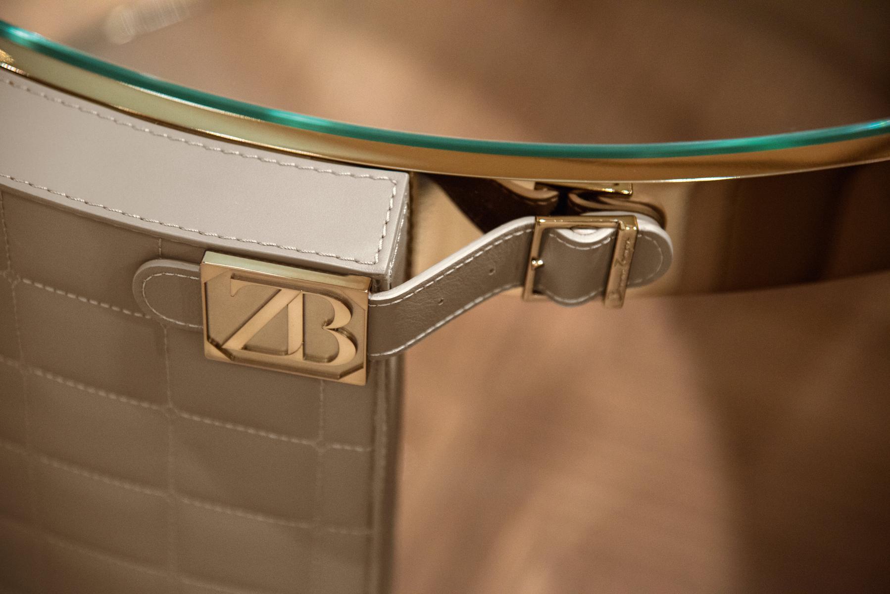 Round coffee table covered in leather and glass top | Rupert by Bruno Zampa