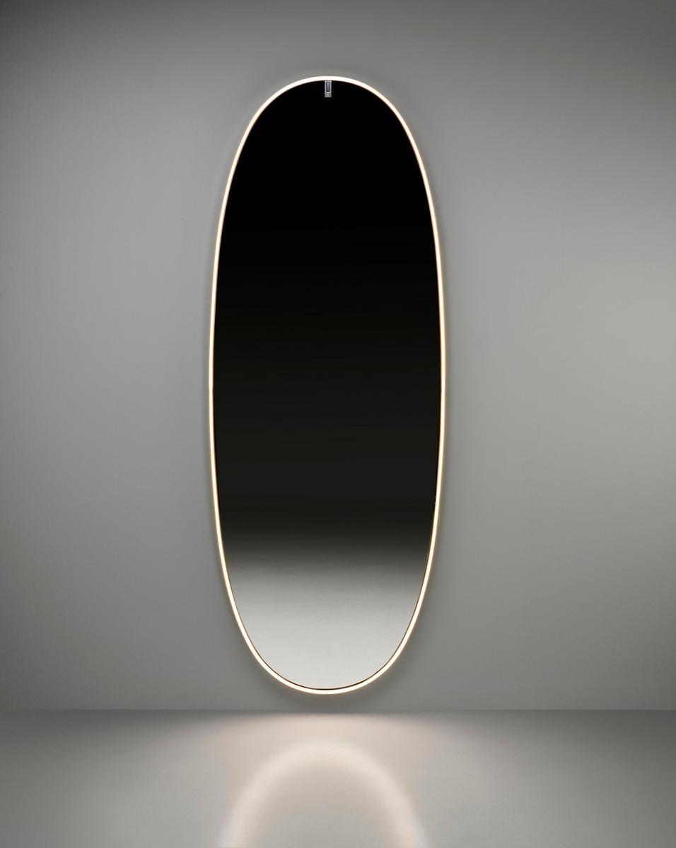 Oval wall-mounted mirror with integrated lighting | La Plus Belle by Flos