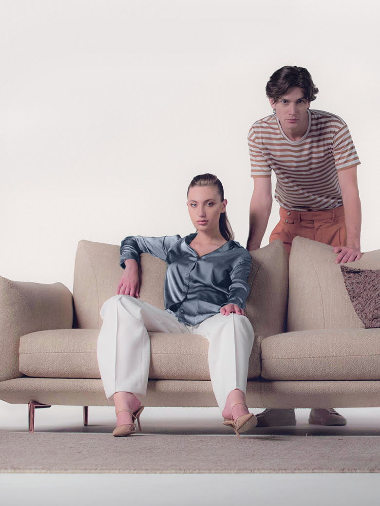 Elegant sectional with heightened backrests for superior comfort, minimal base, and decorative stitching, combining sophistication with supported relaxation. | Dragées by Calia Italia