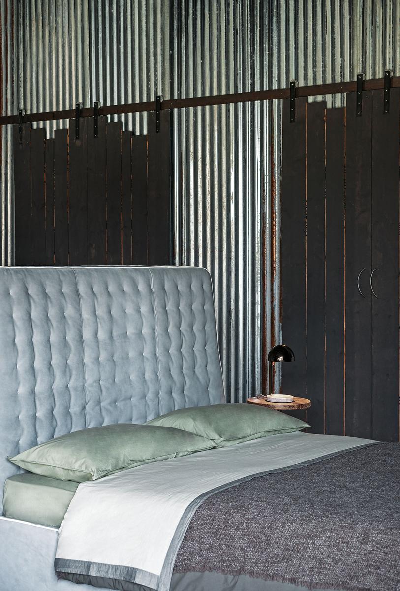 Leather bed with upholstered headboard |  by Baxter