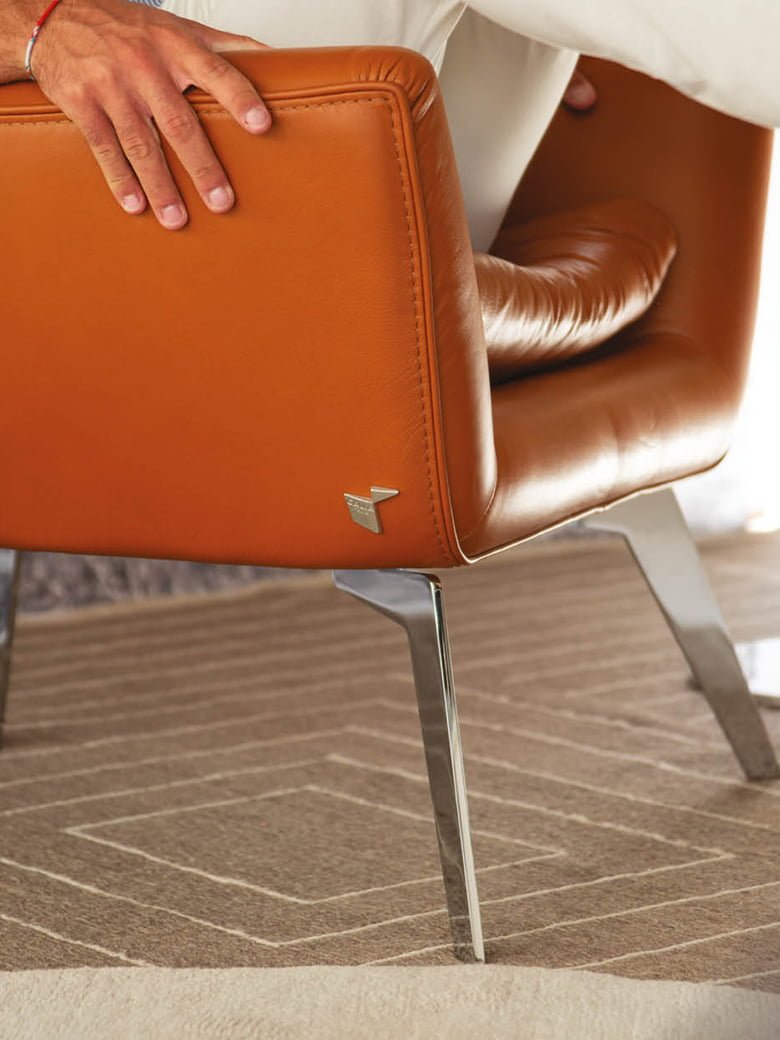 Jacob armchair with feather padding offers unparalleled comfort and timeless 'bergère' style, crafted with natural leathers and fine fabrics for a unique sitting experience. | Jacob by Calia Italia