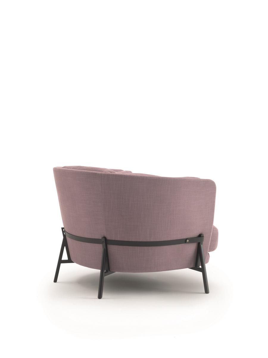 Fabric armchair with armrests with integrated magazine rack | Cradle by Arflex