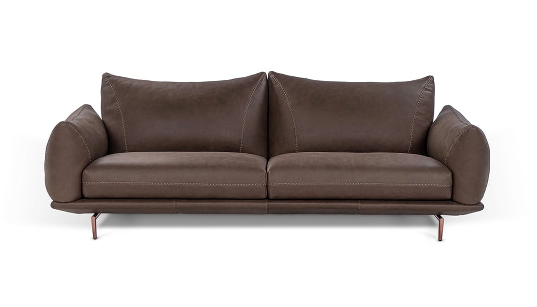 Elegant sectional with heightened backrests for superior comfort, minimal base, and decorative stitching, combining sophistication with supported relaxation. | Dragées by Calia Italia