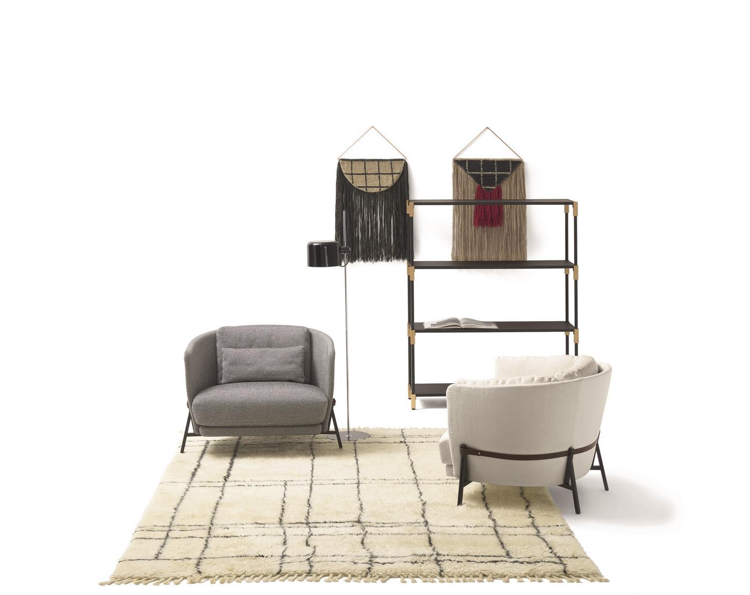 Fabric armchair with armrests with integrated magazine rack | Cradle by Arflex