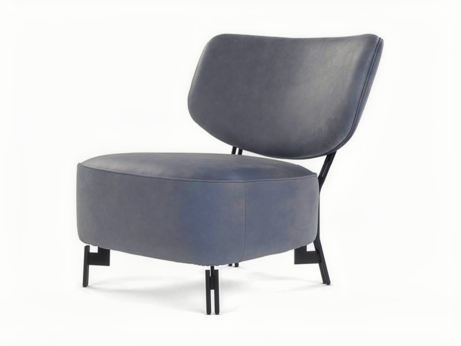 The 'Silla' armchair features a distinctive embracing backrest and sturdy external legs, offering both comfort and a stylized, Scandinavian-inspired design. | Silla by Calia Italia