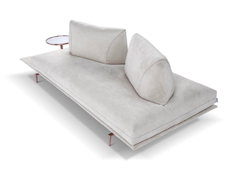 A versatile sofa offering adjustable backrests for multiple seating positions, elegant design stitching, and optional integrated table surfaces, elevated by stylish metal feet. | Gianduiotto by Calia Italia