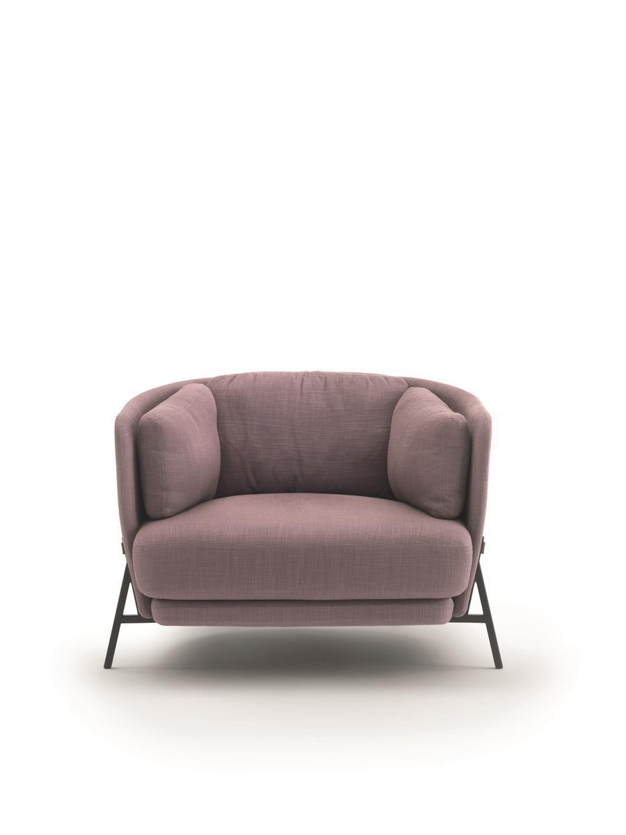 Fabric armchair with armrests with integrated magazine rack | Cradle by Arflex