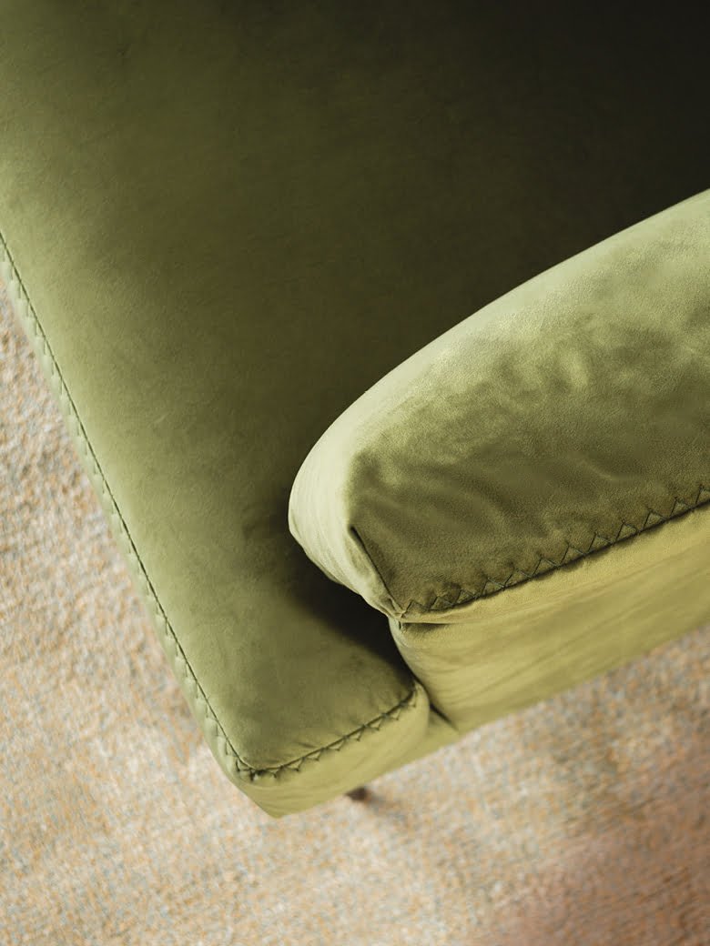 Elegant Fleur chair with stylish pin-shaped legs and sophisticated stitches, ideal for both snug homes and professional spaces, offering comfort in compact form with option for leather or removable fabric. | Fleur by Calia Italia